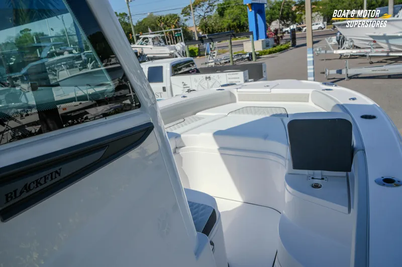 Slide: The Image of 2026 Blackfin 242 HB boat interior at dealership, showcasing seating and design features. - 15
