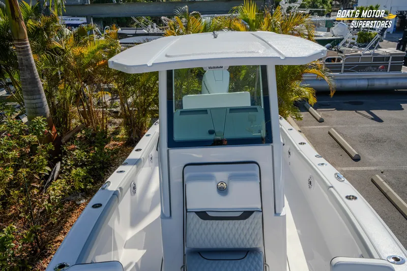 Slide: The Image of 2026 Blackfin 242 HB boat displayed at a dealership with lush greenery. - 19