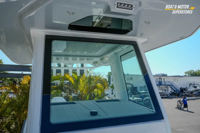 Slide: The Image of 2026 Blackfin 242 HB boat windshield and interior view at dealership. - 21
