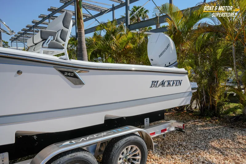 Slide: The Image of 2026 Blackfin 242 HB boat on trailer, surrounded by palm trees. - 3