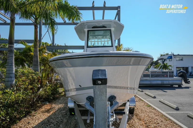 Slide: The Image of 2026 Blackfin 242 HB boat on display at a dealership with palm trees. - 5