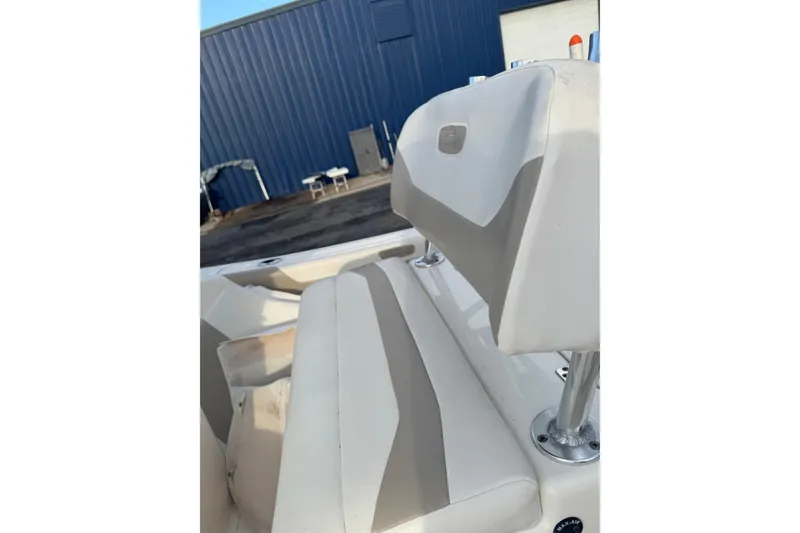 Slide: The Image of 2013 Pioneer 197 Sportfish boat interior with cushioned seating and metal supports. - 11