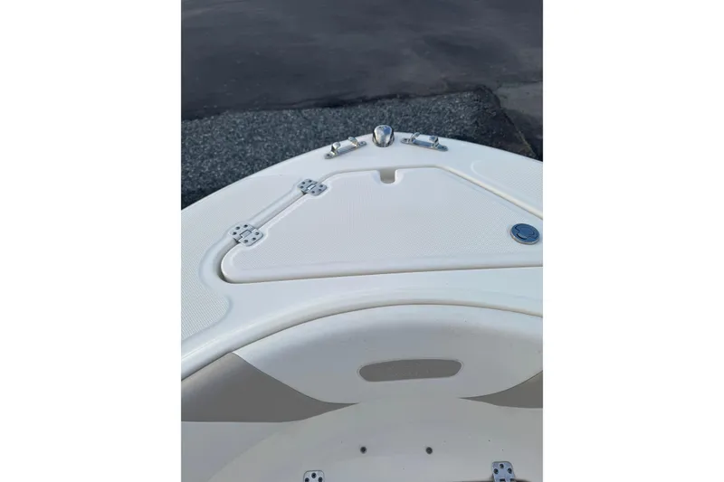 Slide: The Image of Bow of a 2013 Pioneer 197 Sportfish boat, featuring storage hatch and cleats. - 14