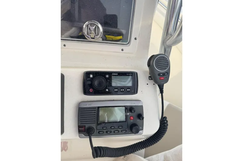 Slide: The Image of Control panel of a 2013 Pioneer 197 Sportfish with radio and microphone. - 18