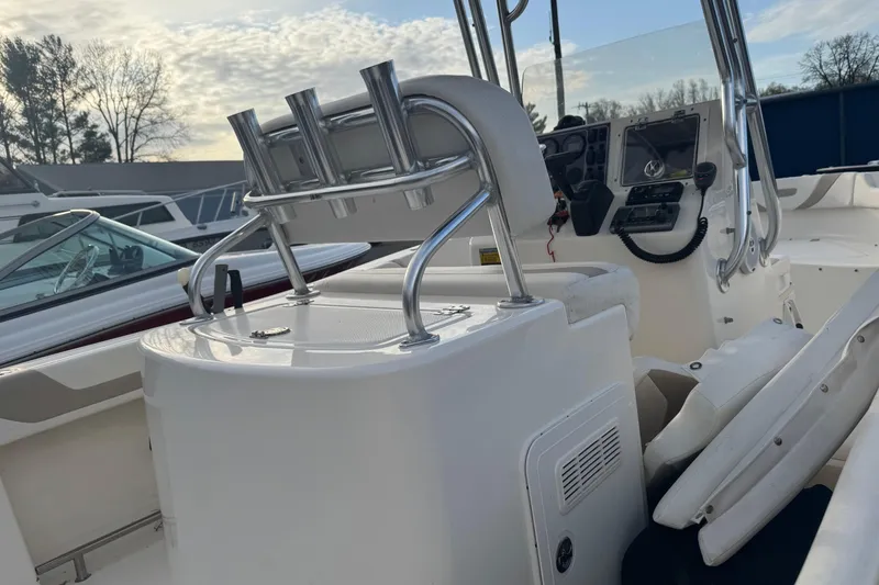 Slide: The Image of 2013 Pioneer 197 Sportfish boat interior with rod holders and control panel. - 5