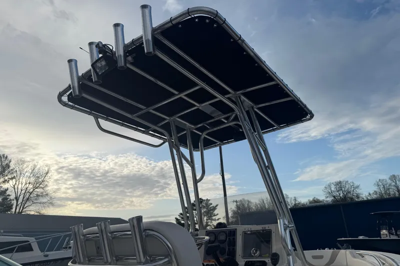 Slide: The Image of 2013 Pioneer 197 Sportfish boat with T-top under a cloudy sky. - 6