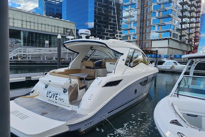 The Image of 2019 Sea Ray Sundancer 350 Coupe docked in urban marina setting. - 0