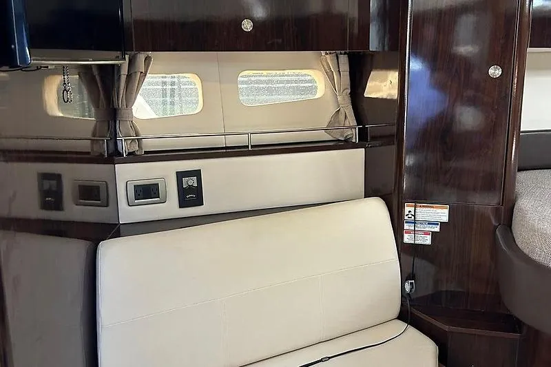 Slide: The Image of Interior of 2019 Sea Ray Sundancer 350 Coupe with elegant seating and wood paneling. - 10