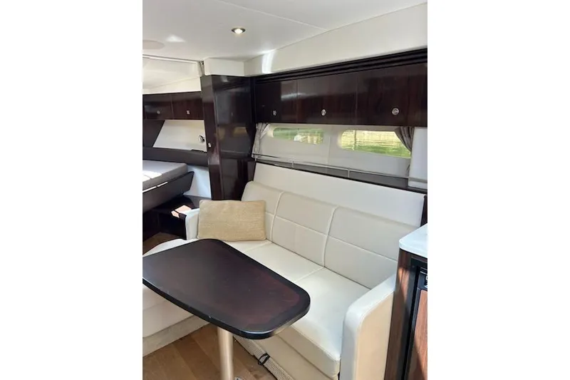 Slide: The Image of Interior of 2019 Sea Ray Sundancer 350 Coupe with elegant seating and wooden accents. - 11