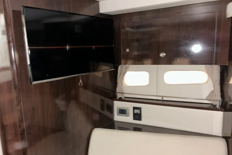 Slide: The Image of Interior of 2019 Sea Ray Sundancer 350 Coupe with TV and wooden cabinetry. - 19