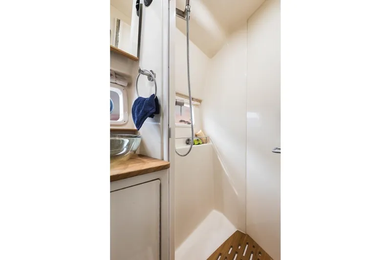 Slide: The Image of Manufacturer Provided Image: 2019 Sea Ray Sundancer 350 Coupe bathroom with shower and wooden floor. - 25