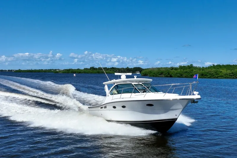 The Image of 2005 Tiara Yachts 3200 Open cruising on a sunny day, leaving a wake behind. - 0