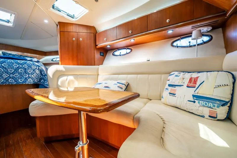 Slide: The Image of Luxurious interior of 2005 Tiara Yachts 3200 Open with plush seating and nautical decor. - 11