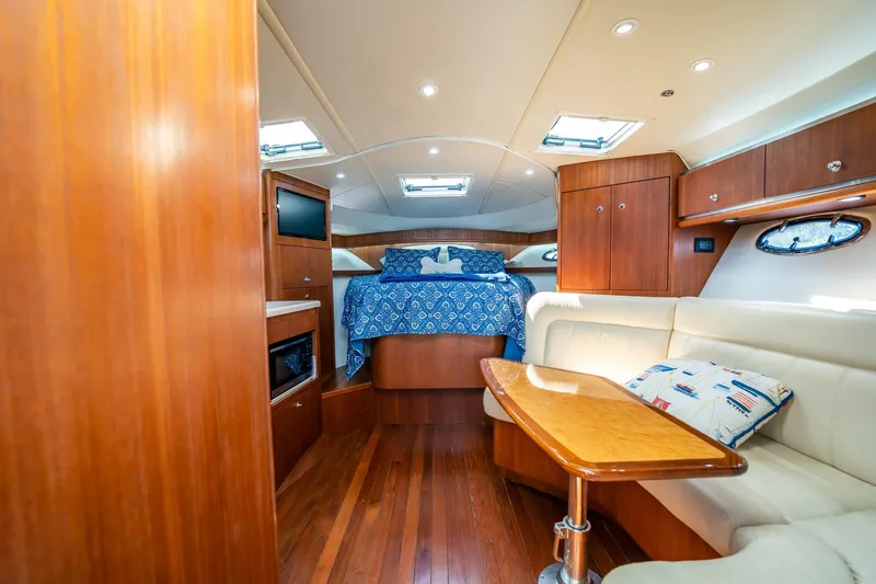 Slide: The Image of Luxurious interior of 2005 Tiara Yachts 3200 Open, featuring wood finishes and cozy seating. - 12