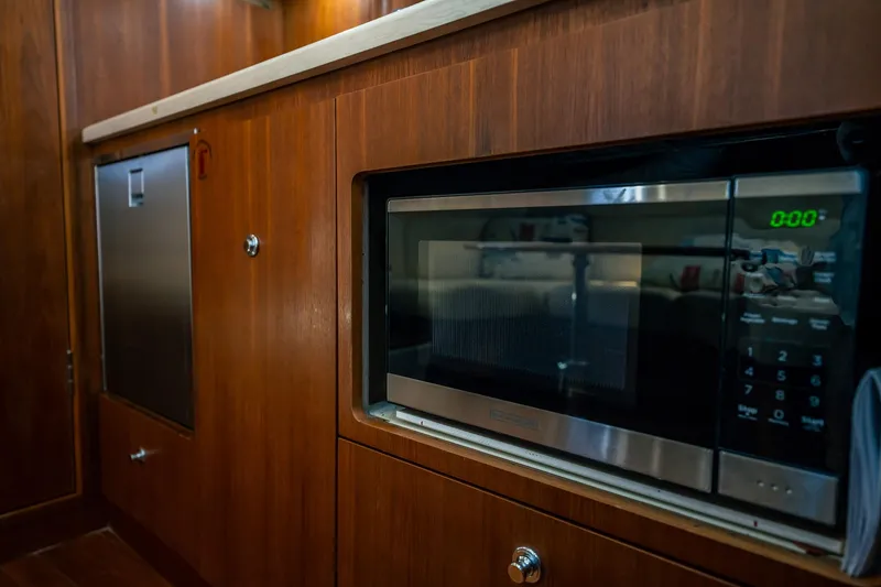 Slide: The Image of 2005 Tiara Yachts 3200 Open interior with microwave and wooden cabinetry. - 14