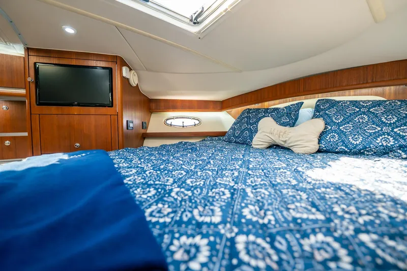 Slide: The Image of Luxurious cabin interior of 2005 Tiara Yachts 3200 Open with cozy bedding and TV. - 18