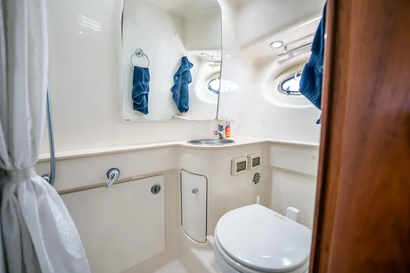 Slide: The Image of 2005 Tiara Yachts 3200 Open bathroom with sink, mirror, and porthole windows. - 20