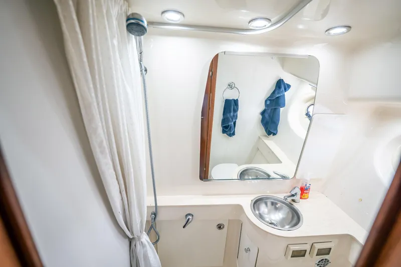 Slide: The Image of 2005 Tiara Yachts 3200 Open bathroom with shower, sink, and mirror. - 21