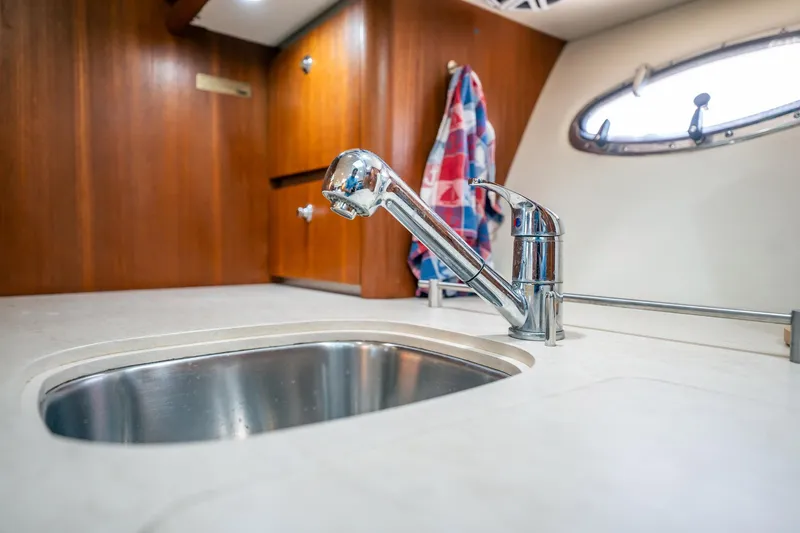 Slide: The Image of 2005 Tiara Yachts 3200 Open interior with sink and faucet in wooden cabin. - 22