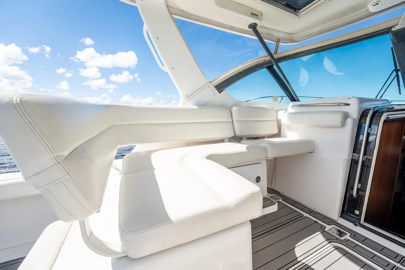 Slide: The Image of 2005 Tiara Yachts 3200 Open interior with white seating and ocean view. - 29
