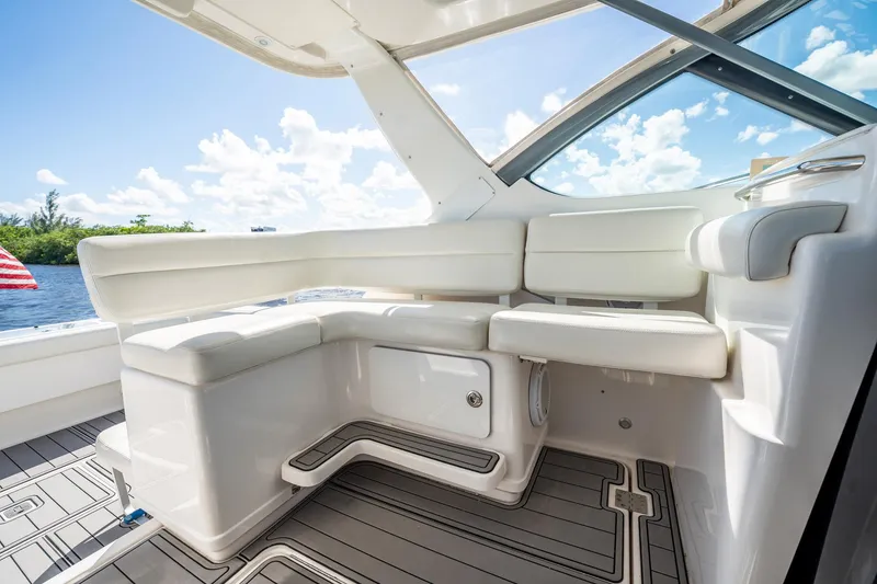 Slide: The Image of 2005 Tiara Yachts 3200 Open interior with white seating and scenic water view. - 31