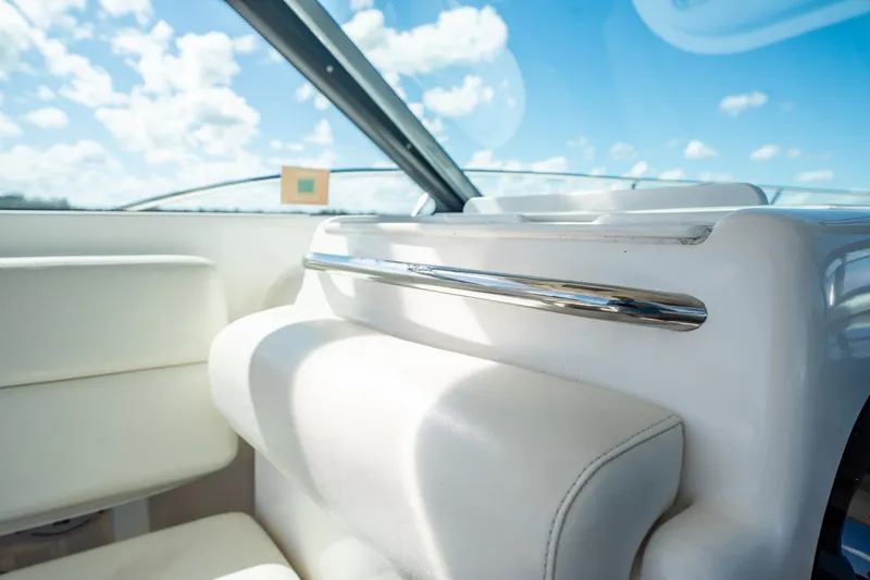 Slide: The Image of Interior view of 2005 Tiara Yachts 3200 Open, featuring white seating and chrome accents. - 32