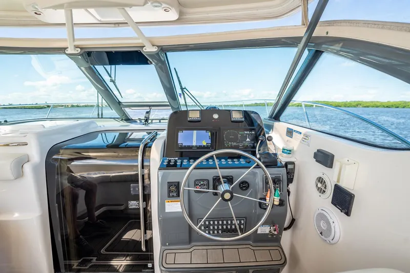 Slide: The Image of Helm of 2005 Tiara Yachts 3200 Open, featuring navigation controls and scenic water view. - 34
