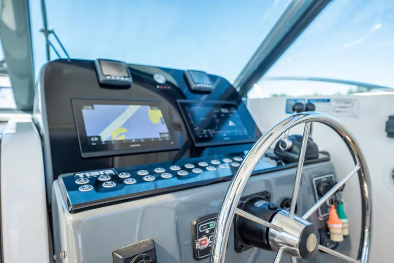 Slide: The Image of Helm of 2005 Tiara Yachts 3200 Open with navigation displays and steering wheel. - 35