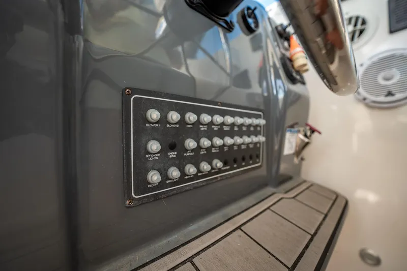 Slide: The Image of Control panel on 2005 Tiara Yachts 3200 Open, featuring various switches and buttons. - 36