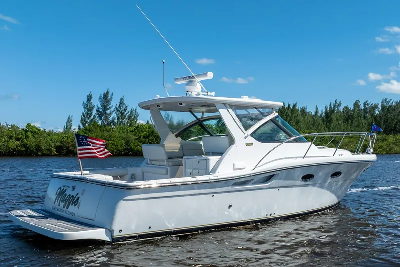 Slide: The Image of 2005 Tiara Yachts 3200 Open cruising on a sunny day with American flag. - 4