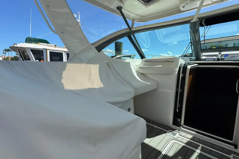 Slide: The Image of 2005 Tiara Yachts 3200 Open cockpit with covered seating and clear sky view. - 43