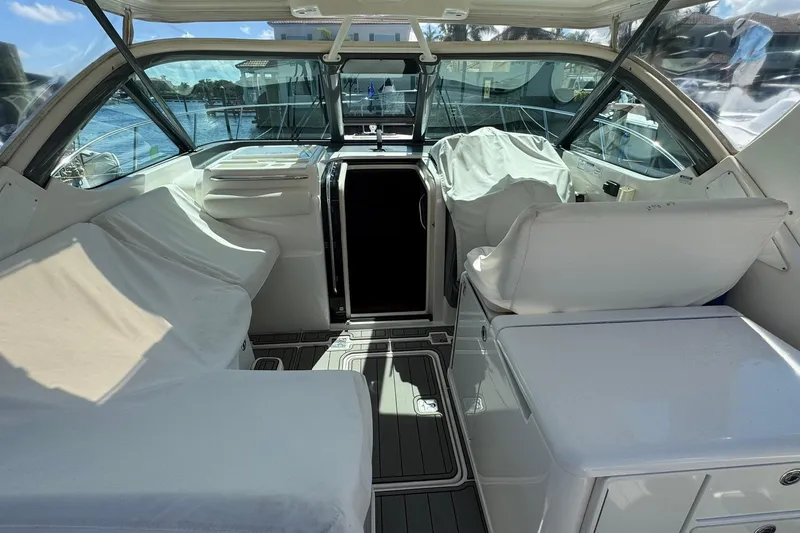 Slide: The Image of 2005 Tiara Yachts 3200 Open cockpit with covered seating and helm, docked by the water. - 44