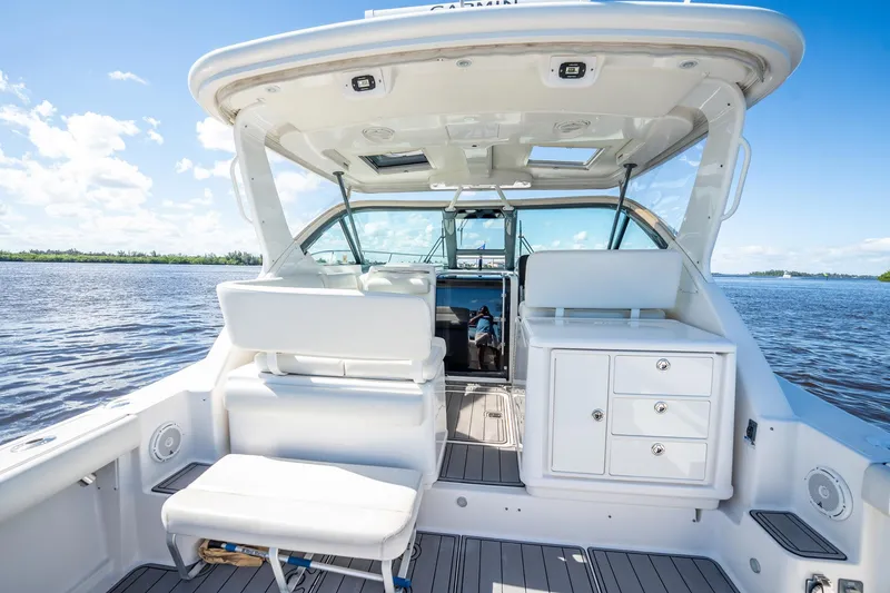 Slide: The Image of 2005 Tiara Yachts 3200 Open boat interior with seating and storage, on a sunny day. - 45