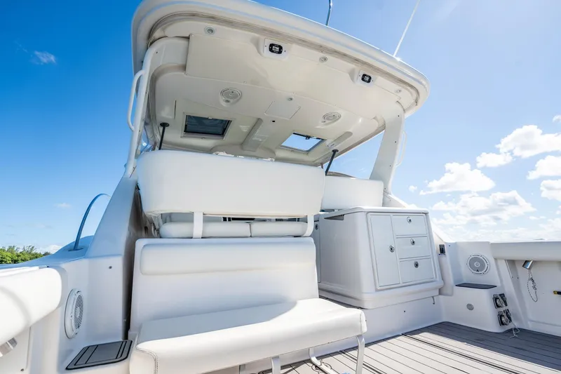 Slide: The Image of 2005 Tiara Yachts 3200 Open boat interior with seating and storage under clear blue sky. - 49