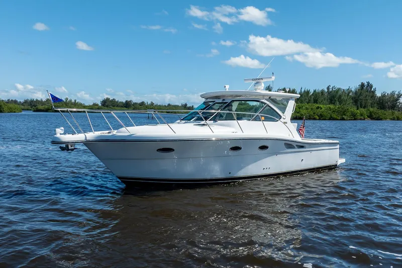 Slide: The Image of 2005 Tiara Yachts 3200 Open cruising on a sunny day, surrounded by calm waters. - 5