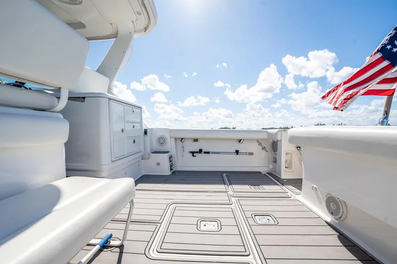 Slide: The Image of 2005 Tiara Yachts 3200 Open deck with American flag, clear sky background. - 51