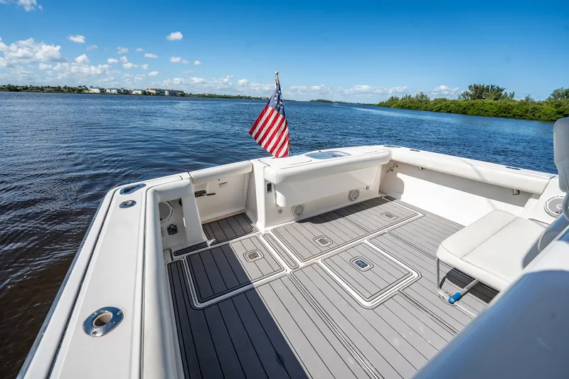 Slide: The Image of 2005 Tiara Yachts 3200 Open boat deck with American flag, on calm water. - 53