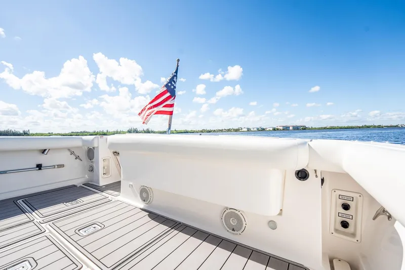 Slide: The Image of 2005 Tiara Yachts 3200 Open deck with American flag, clear sky, and water view. - 55