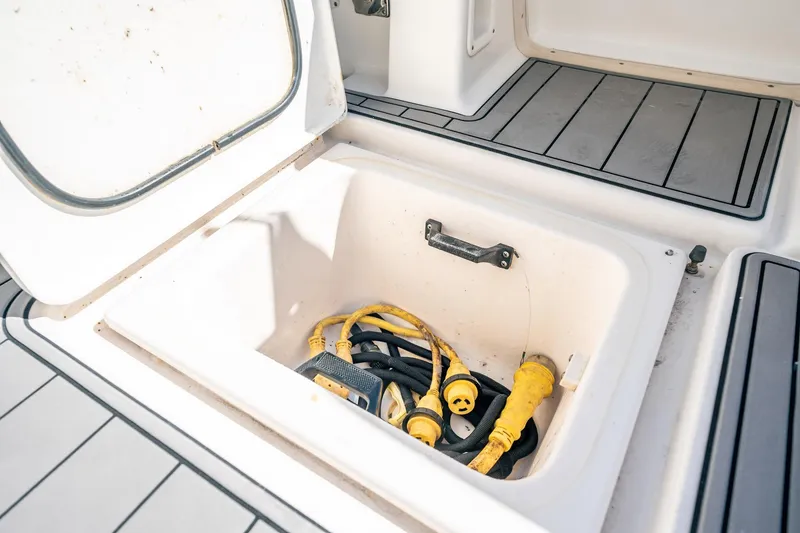 Slide: The Image of Storage compartment on 2005 Tiara Yachts 3200 Open with yellow power cables. - 58