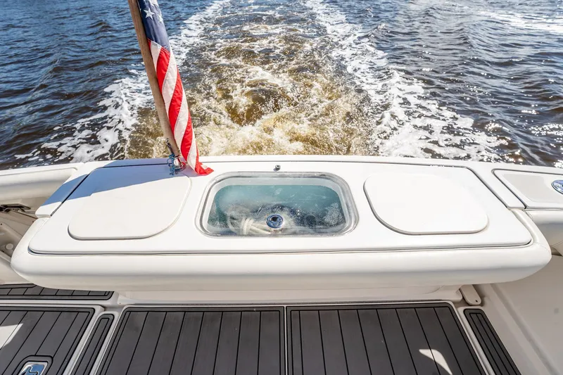 Slide: The Image of 2005 Tiara Yachts 3200 Open stern view with American flag and ocean wake. - 60