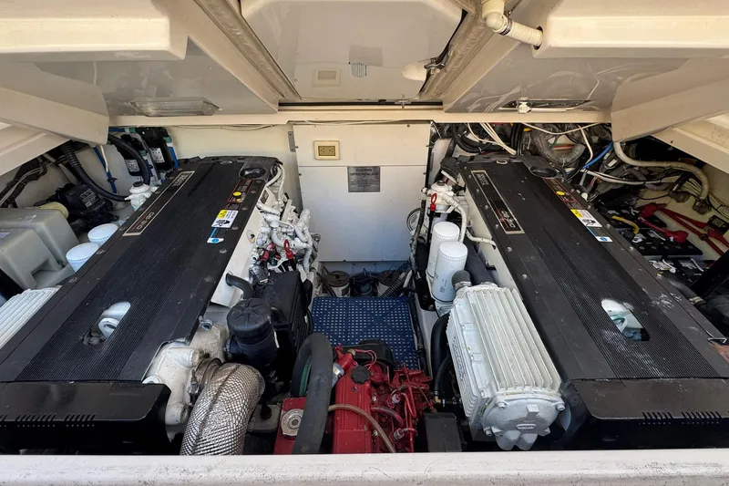 Slide: The Image of Engine compartment of a 2005 Tiara Yachts 3200 Open, showcasing dual engines and mechanical components. - 62