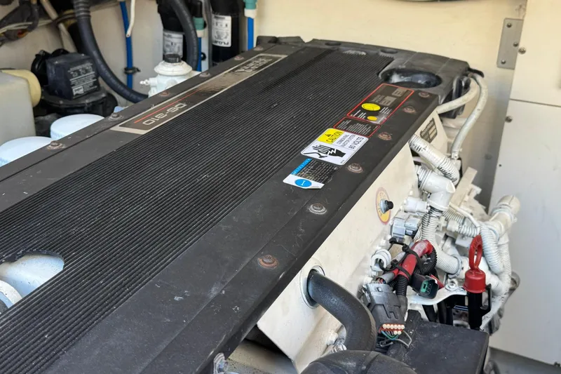 Slide: The Image of Engine compartment of a 2005 Tiara Yachts 3200 Open, showcasing detailed components and wiring. - 63