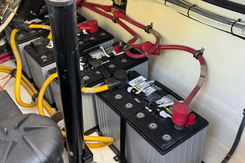 Slide: The Image of Battery compartment of a 2005 Tiara Yachts 3200 Open with connected cables. - 67