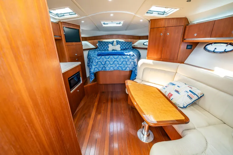 Slide: The Image of Luxurious interior of 2005 Tiara Yachts 3200 Open with wood finish and cozy seating. - 7