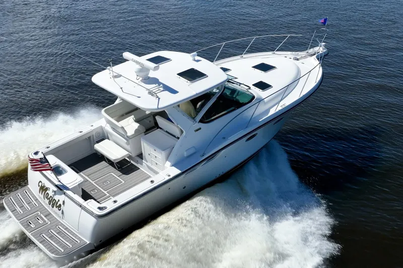 Slide: The Image of 2005 Tiara Yachts 3200 Open cruising on water, rear view, American flag displayed. - 72