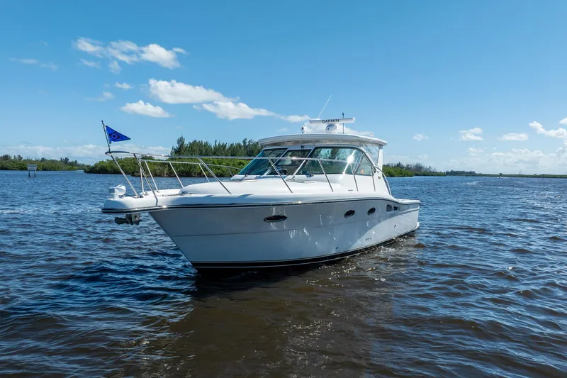 Slide: The Image of 2005 Tiara Yachts 3200 Open cruising on a sunny day, blue sky, calm waters. - 74