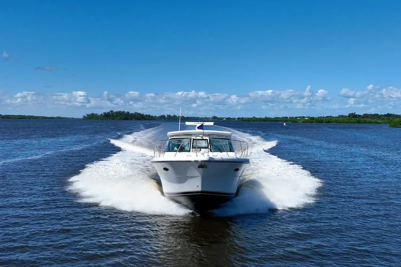 Slide: The Image of 2005 Tiara Yachts 3200 Open cruising on a sunny day, creating a wake in the water. - 75