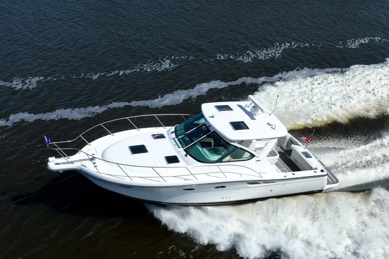 Slide: The Image of 2005 Tiara Yachts 3200 Open cruising on water, creating a dynamic wake. - 78