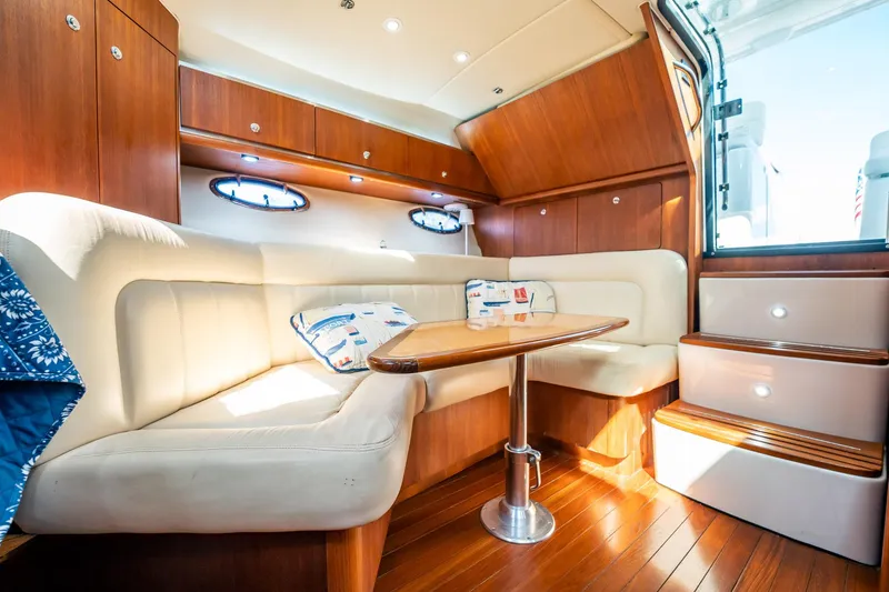 Slide: The Image of Luxurious 2005 Tiara Yachts 3200 Open interior with elegant wood finish and plush seating. - 8
