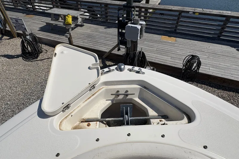 Slide: The Image of Open anchor compartment on 2012 Pioneer 197 Venture boat at dockside. - 11
